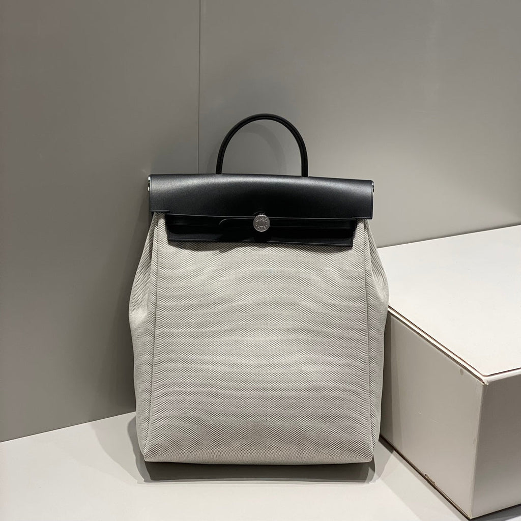 HERBAG A DOS ZIP RETOURNE BACKPACK 29 IN OFF-WHITE CANVAS AND BLACK CALFSKIN